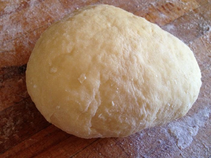 Hozzáadjuk a vajat, és hólyagosra dagasztjuk. A megdagasztott tésztát konyharuhával letakarva meleg helyen legalább a duplájára kelesztjük. Amikor megkelt, lisztezett deszkára borítjuk, majd, kézzel kis gömböket formázunk belőle. Visszatesszük a deszkára, letakarjuk a konyharuhával, és ismét megkelesztjük.