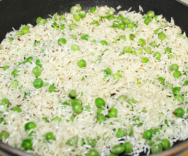 A rizst kókuszolajon gipsz-fehérre sütjük, megszórjuk az apróra vágott petrezselyemmel, beletesszük a borsót, felöntjük kétszeres mennyiségű vízzel, sózzuk és lassú tűzön 15 perc alatt puhára pároljuk.