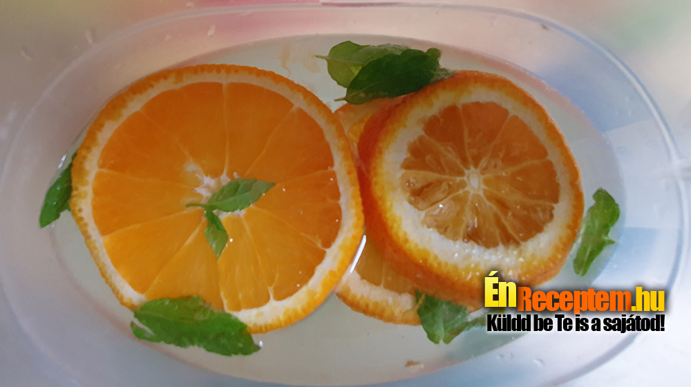 A gyümölcsök végeit úgy szoktam levágni, hogy egy kicsit nagyobbat vágok, hogy bele tudjam facsarni onnan is a levét. A kancsót háromnegyedig töltjük vízzel, beletesszük a cukrot, alaposan elkeverjük, és hozzáadjuk a felkarikázott gyümölcsöket és a leveleire szedett mentát. Nálunk az a menő, ha savanykás, mert az tényleg oltja a szomjat. Jól behűtve fogyasztjuk! Öntéskor ügyeljünk, hogy minden pohárba jusson minden gyümölcsből.
A kancsóban csak a narancs és a menta látható, mert a lime és a citrom lehúzódott az aljára.